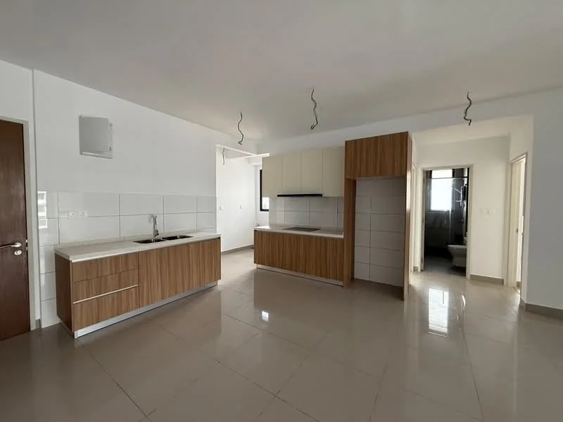Kitchen features: white tiled walls, cream cabinetry, wooden lower cabinets, stainless-steel sink, chrome pull-down faucet, countertop with integrated cooktop, open layout, tile flooring, recessed downlights; style: modern. Room features: white painted walls, tile flooring, doorway leading to bathroom, natural light from window.
