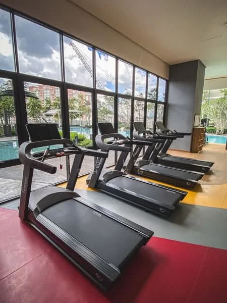 Room features: large floor-to-ceiling windows, treadmills, rubber flooring, wooden paneling, natural light, view of outdoor greenery, exercise area, modern design; style: modern; view: garden.