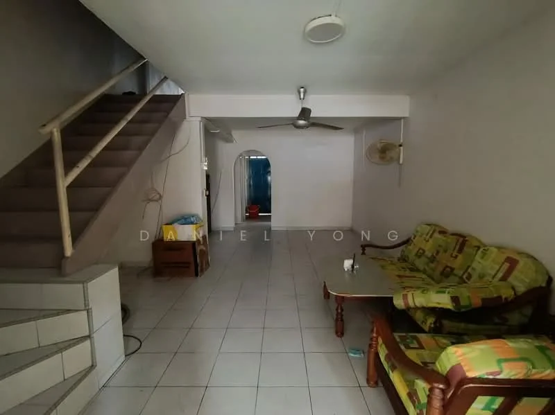 Living features: green and yellow patterned upholstery on sofa, wooden coffee table, ceiling fan, white walls, tile flooring, staircase leading to upper floor, wall-mounted air conditioning unit, open layout, natural light from window, decorative wall-mounted fan.