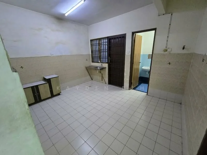 Room features: white painted walls, cream tiled walls, light grey floor tiles, single-basin sink, wooden cabinetry, doorway leading to bathroom, window with security bars, fluorescent ceiling light.