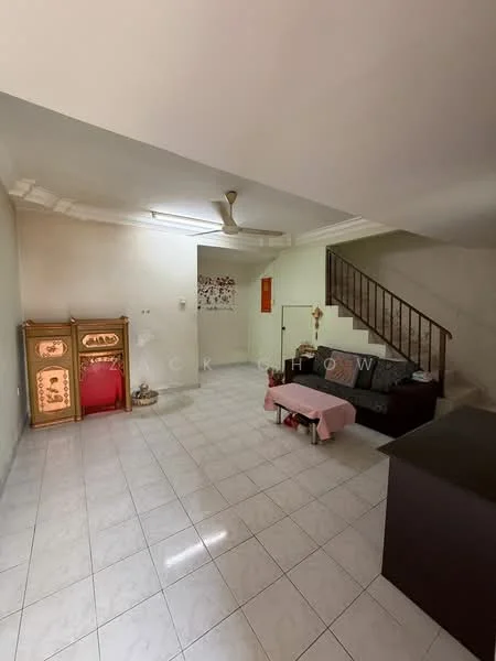 Living features: white painted walls, ceramic tile flooring, 5-blade ceiling fan, sofa in dark fabric, coffee table, staircase with wooden railing, decorative cabinet with red and gold accents, wall-mounted artwork, natural light from windows.