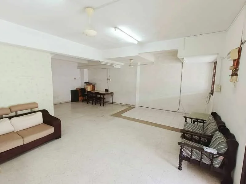 Living features: white painted walls, tile flooring, ceiling with fluorescent lighting, 2 ceiling fans, sofa with brown upholstery, wooden coffee table, dining table with chairs, open layout, large windows, neutral color scheme.