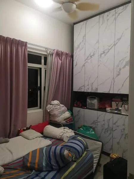 Bedroom features: single bed with striped bedding, pillow and rolled blankets on bed, built-in wardrobe with marble-patterned doors, curtains in light pink color, floor lamp, ceiling fan, window with black frame, decorative items on top of wardrobe.