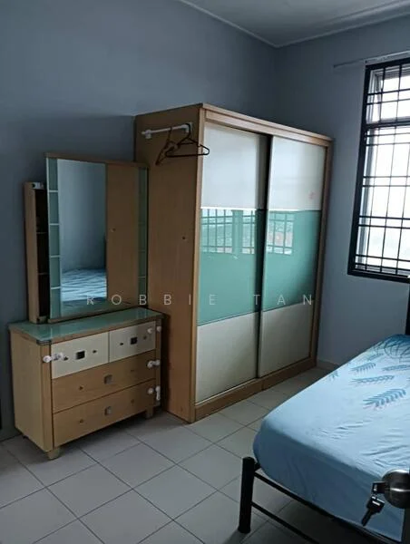 Bedroom features: single bed with blue bedding, built-in wardrobe with sliding doors, dressing table with mirror, chest of drawers, white tiled flooring, grey painted walls, window with grid pattern, hanging rod for clothes.