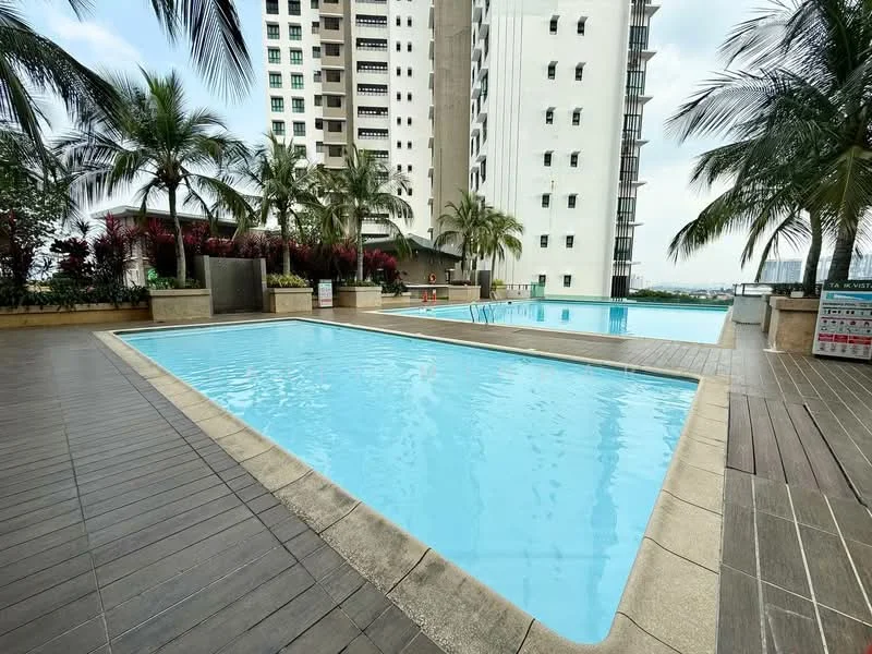 Exterior type: high-rise condominium; features: infinity pool, lap pool, pool deck with loungers, tropical landscaping with palm trees, manicured garden beds, surrounding high-rise buildings, city skyline view in background; style: modern.