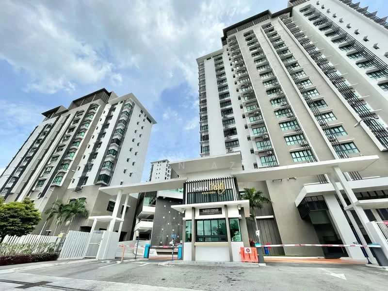 Exterior type: high-rise condominium; features: glass curtain wall, white painted facade, recessed balconies, multiple storeys, main entrance gate with security, landscaped greenery at entrance, paved driveway, visible parking area; style: modern.