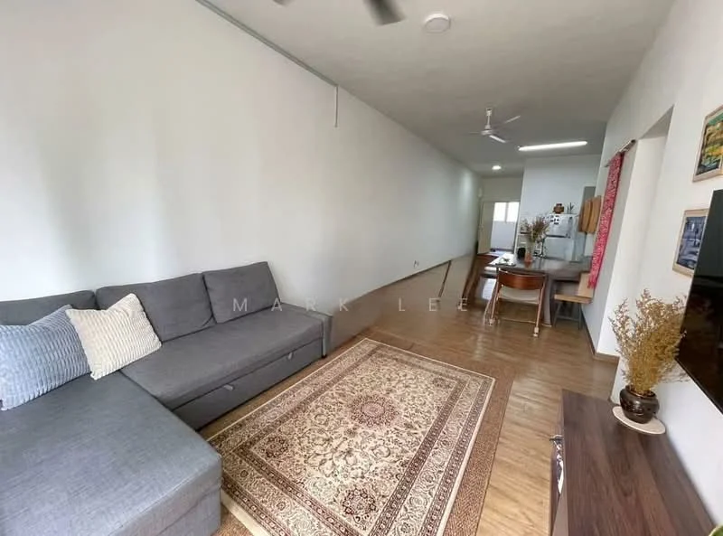 Living features: L-shape sectional sofa in grey, area rug with intricate pattern, wooden flooring, white painted walls, ceiling fan, wall-mounted TV, TV console, decorative wall art, natural light from windows, open layout to kitchen, neutral color scheme; style: modern. Room features: white painted walls, wooden flooring, natural light from windows.