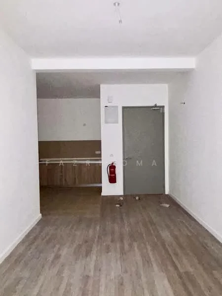 Room features: light wood laminate flooring, white painted walls, ceiling light fixture, fire extinguisher mounted on wall, open layout to kitchen area, door leading to another room, no visible furniture or decor; style: modern.