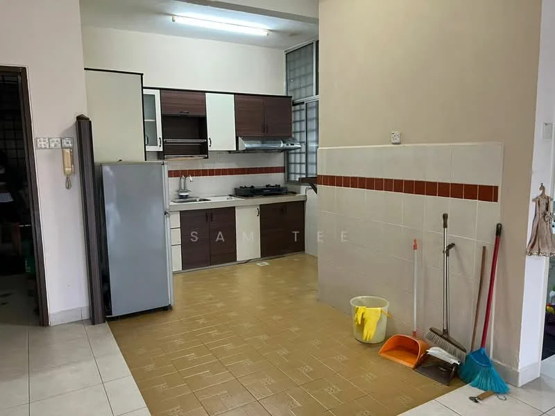 Kitchen features: brown wooden cabinetry, white countertop, stainless-steel sink, gas stove with 4 burners, built-in exhaust hood, refrigerator, tile backsplash, cream tiled flooring, window with metal grille, cleaning supplies, broom and dustpan.