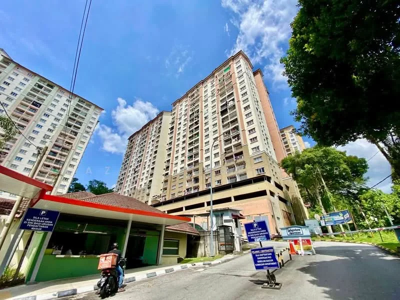 Exterior type: high-rise condominium; features: multi-storey building, concrete facade, balconies on upper floors, parking area underneath, surrounded by greenery, signage for property management, road access, clear blue sky; style: modern.