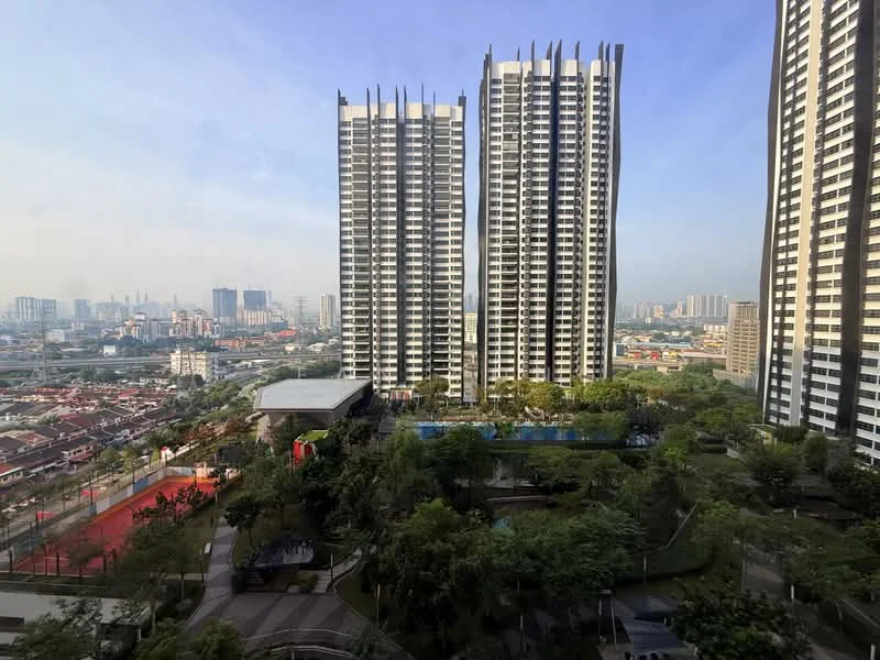 Exterior type: high-rise condominium; features: glass curtain wall, recessed balconies, vertical fins, manicured lawn, mature trees, swimming pool, outdoor amenities, surrounded by greenery, urban skyline view, multi-storey buildings; style: modern.