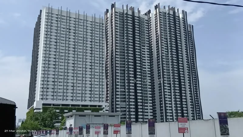 Exterior type: high-rise condominium; features: glass curtain wall, white painted facade, vertical fins, approximately 20-storey high-rise, surrounded by mature greenery, multiple balconies, modern architectural design; style: modern.