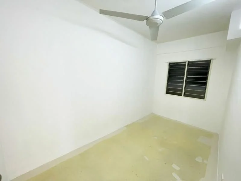 Room features: white painted walls, ceiling fan, window with metal grille, plain flooring, no visible furniture.