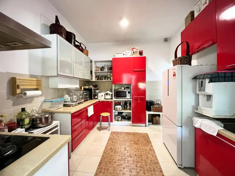 Kitchen features: red high-gloss cabinetry, white countertop, stainless-steel sink, chrome pull-down faucet, built-in microwave, freestanding refrigerator, freestanding oven, ceramic tile flooring, recessed downlights, open shelving, kitchen island with seating, decorative basket on cabinet, area rug with geometric pattern; style: modern.