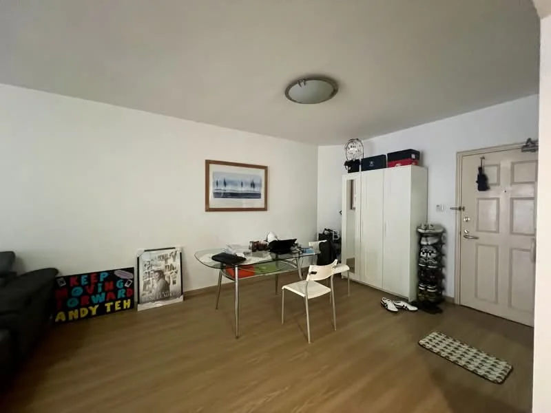 Living features: light wood laminate flooring, white painted walls, ceiling light fixture, glass dining table, white dining chairs, black sofa, framed artwork on wall, shoe cabinet, decorative wall art, door with security grill; style: modern.