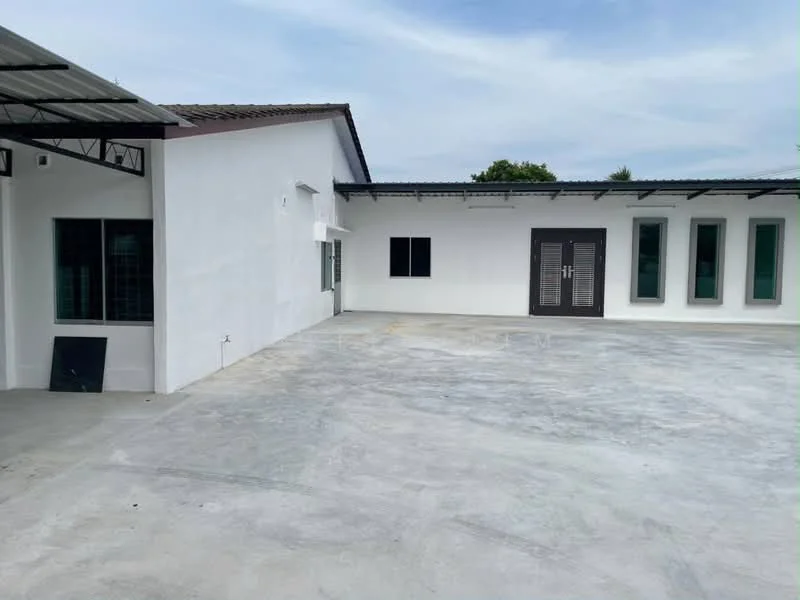 Exterior type: detached bungalow; features: white painted facade, flat roof, concrete flooring, multiple windows, double-door main entrance, manicured lawn, surrounded by greenery; style: modern.