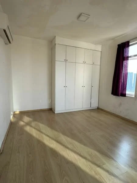 Bedroom features: laminate flooring, white painted walls, built-in wardrobe with sliding doors, window with purple curtains, 1 wall-mounted split AC, ceiling light fixture, natural light from window.