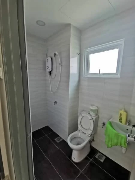 Bathroom features: white tiled walls, grey tiled flooring, walk-in shower with glass enclosure, chrome shower head, toilet, small sink, window for natural light, water heater on wall, green towel hanging; style: modern.