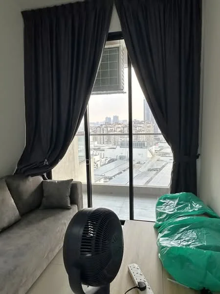 Living features: grey fabric sofa, throw pillow, floor-to-ceiling sliding glass door, blackout curtains, wall-mounted split AC, ceiling fan, wooden flooring, green plastic covering on furniture, view of city skyline; style: modern; view: city.