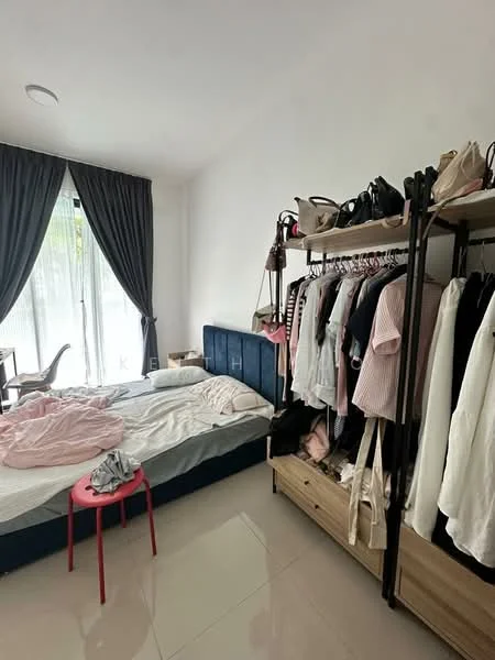 Bedroom features: queen-size bed with blue upholstered headboard, white bedding, floor-to-ceiling windows with sheer curtains, grey accent wall, light-coloured tiled flooring, clothing rack with various garments, wooden dresser, pink stool, study desk, decorative wall art; style: modern; view: garden.