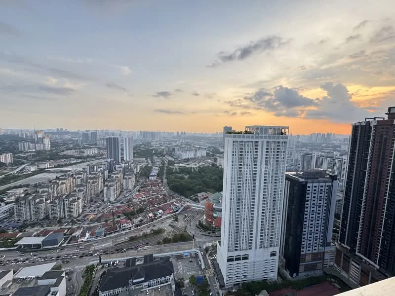 Exterior type: high-rise condominium; features: city skyline view, surrounded by urban landscape, multiple high-rise buildings, sunset in the background, highway visible, greenery in the foreground; style: modern.