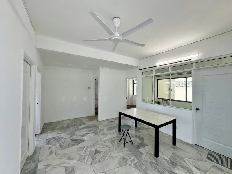 Room features: white painted walls, marble tile flooring, 5-blade ceiling fan with light, large windows, glass partition, dining table with black legs and white top, metal stool, door leading to another room, light fixture on ceiling, neutral color scheme; style: modern.