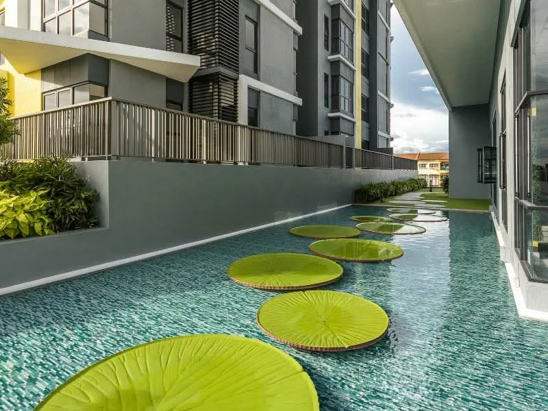 Exterior type: high-rise condominium; features: water feature with lily pads, landscaped garden area, modern architecture, glass windows, balcony with railing, manicured greenery, poolside area, reflective water surface; style: modern.