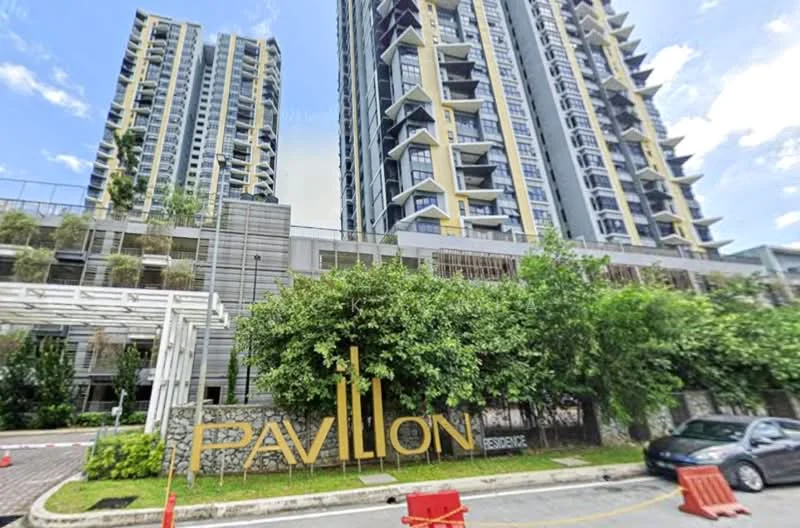 Exterior type: high-rise condominium; features: glass curtain wall, green landscaping with trees, manicured lawn, feature signage with 'PAVILION', multiple storeys, balconies on upper floors, surrounding greenery, driveway with barriers; style: modern.