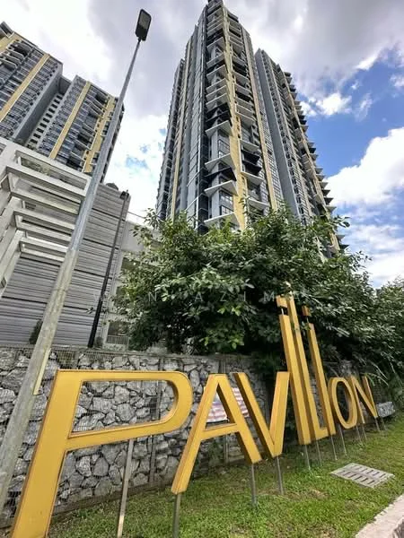 Exterior type: high-rise condominium; features: glass curtain wall, yellow accent panels, stone cladding at base, landscaped garden with shrubs, signage with name 'PAVILION', multiple balconies, modern architectural design, surrounded by greenery; style: modern.
