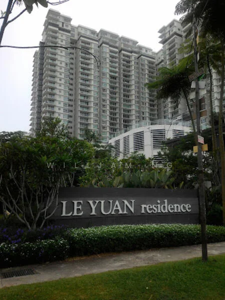 Exterior type: high-rise condominium; features: modern glass facade, landscaped garden with shrubs, signage with 'LE YUAN residence', multiple storeys, balconies on upper floors, mature trees in vicinity, manicured lawn, paved walkway; style: modern.