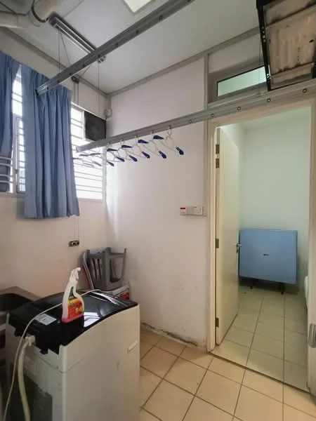 Laundry features: front-load washing machine, white tiled flooring, white painted walls, window with blue curtains, clothes drying rack, door leading to another room, light fixture on ceiling.
