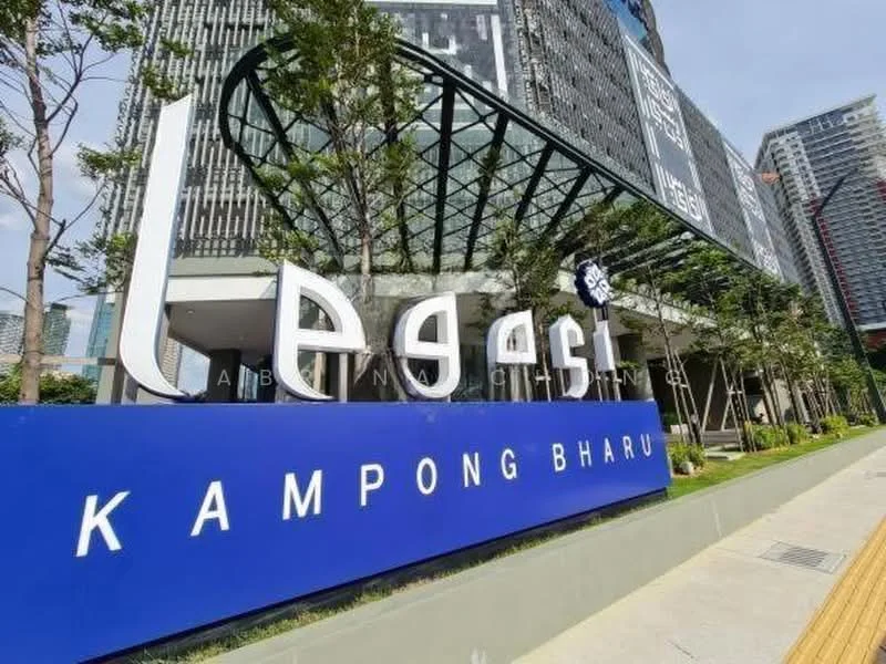 Exterior type: high-rise condominium; features: modern facade with glass and concrete, prominent signage, landscaped entrance with trees, covered walkway, surrounding urban environment, adjacent to high-rise buildings; style: modern.