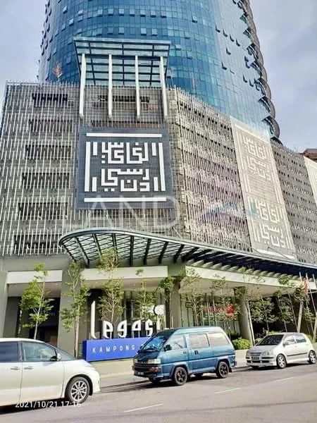 Exterior type: high-rise condominium; features: glass curtain wall, decorative facade with geometric patterns, multiple levels, manicured landscaping, entrance with awning, surrounded by urban context, visible parking area; style: modern.