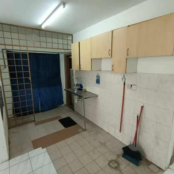 Kitchen features: white tiled walls, light grey tiled flooring, wooden cabinetry with light finish, stainless-steel sink, metal countertop, blue curtain, cleaning broom, dustpan, open shelving, wall-mounted hooks.