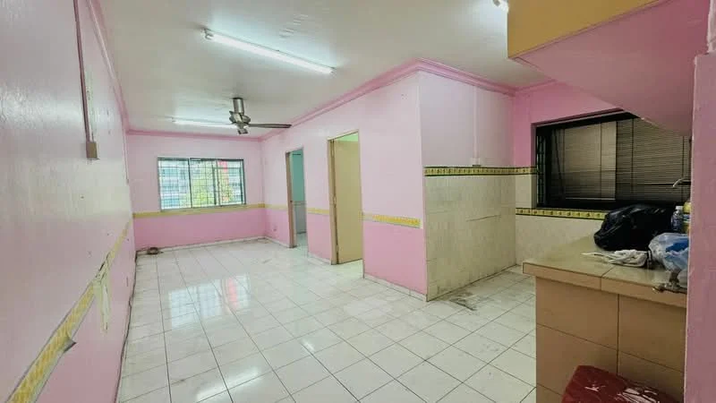 Room features: pink painted walls, white tiled flooring, fluorescent ceiling lights, window with blinds, kitchen countertop, sink, open layout, corner with unfinished wall, doorway to another room, wall tiles in kitchen area.