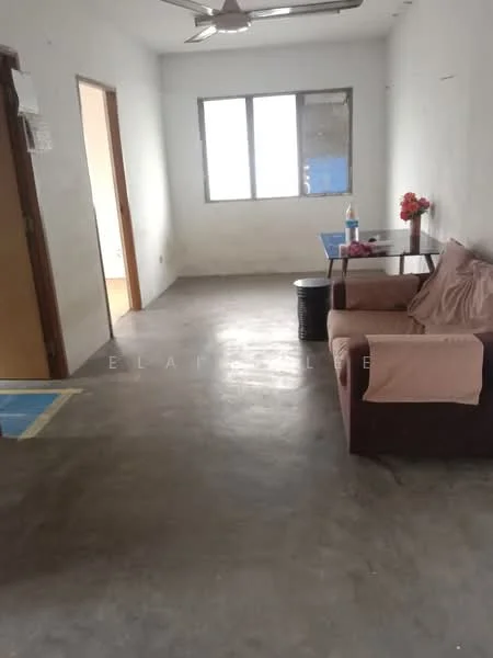 Living features: concrete flooring, white painted walls, ceiling fan, single window, brown fabric sofa, small dining table, decorative flowers on table, black barrel as side table.