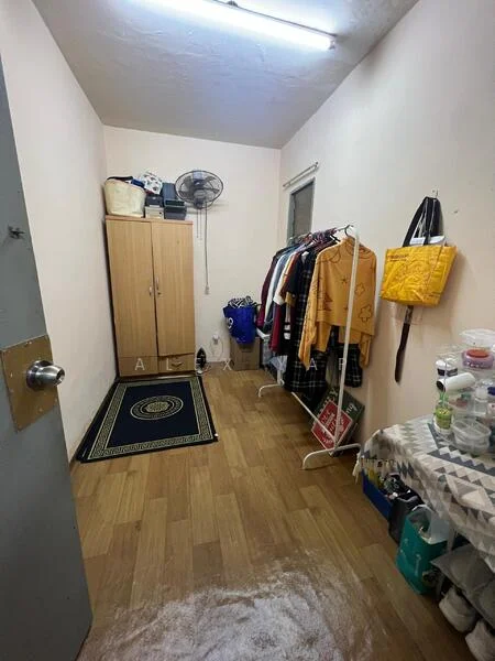 Room features: light wood flooring, white painted walls, ceiling fan, window with curtain, wardrobe with sliding doors, clothing rack, area rug with geometric pattern, storage containers, shelves with various items.