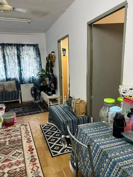 Room features: wooden flooring, white painted walls, ceiling fan, floor-to-ceiling windows with sheer curtains, decorative area rug with geometric pattern, sofa with patterned upholstery, dining table with metal legs, plastic storage containers, indoor plants, wall-mounted shelves, doorway leading to another room, doorway leading to a bathroom; style: minimalist.
