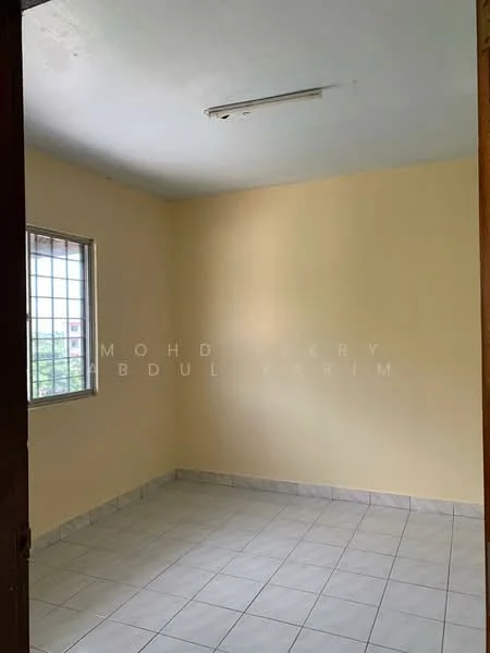 Room features: light yellow painted walls, white ceiling, square ceramic tile flooring, single window with grid pattern, no visible furniture, neutral decor, plain light fixture, corner entry door; style: minimalist; view: garden.
