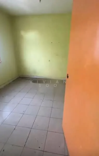 Room features: yellow painted walls, orange door, tile flooring, single window, no visible furniture, plain ceiling, minimal decor.