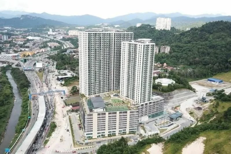 Exterior type: high-rise condominium; features: glass curtain wall, multiple towers, green rooftop garden, surrounding landscaping, parking deck, adjacent to main road, mountain view in background, urban context with nearby development; style: modern.