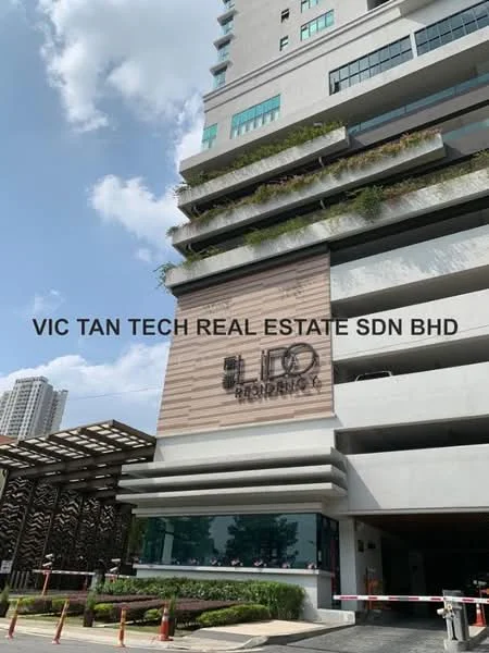 Exterior type: high-rise condominium; features: glass curtain wall, cream painted facade, recessed balconies, feature lighting at night, manicured landscaping, entrance with decorative paneling, security gate, surrounded by urban environment; style: modern.