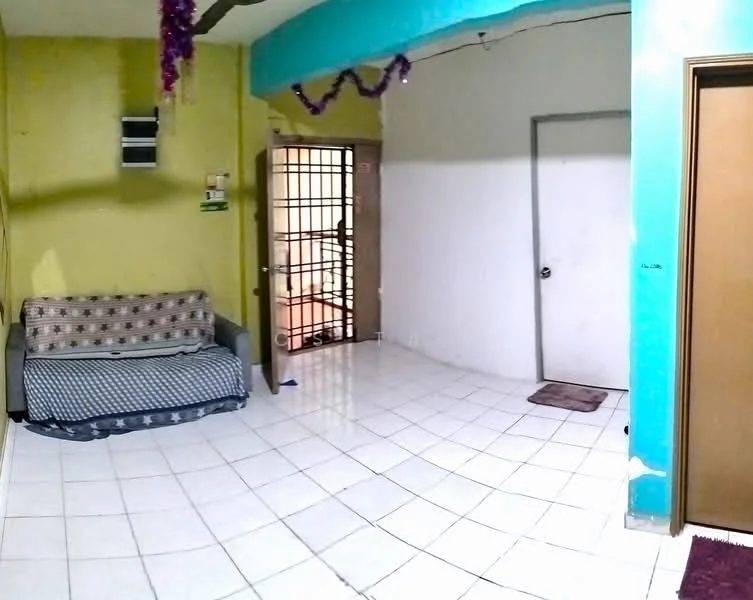 Room features: green painted walls, yellow painted walls, white tiled flooring, sofa with patterned upholstery, metal security door, interior door, decorative ceiling with hanging ornaments, window air conditioning unit.