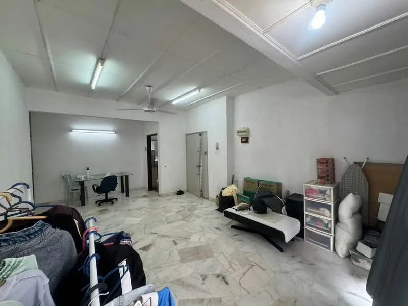 Room features: white painted walls, marble flooring, ceiling fan, recessed lighting, clothes rack with hanging clothes, plastic storage drawers, folding mattress, ironing board, table with chairs, door leading to another room; style: minimalist.