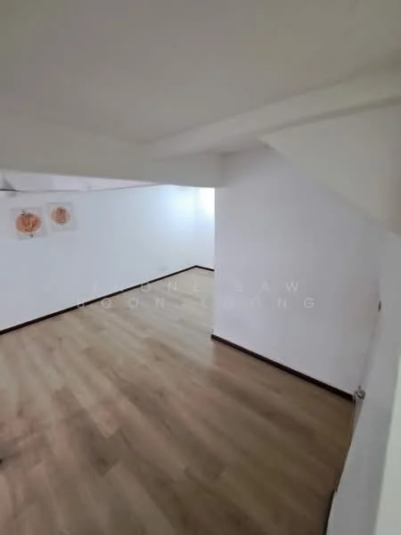 Room features: white painted walls, laminate flooring, decorative wall art, staircase visible, corner space, natural light, neutral color scheme; style: modern.
