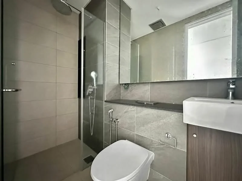 Bathroom features: walk-in shower with glass enclosure, rain shower head, handheld shower, single-sink vanity with wood cabinet, chrome basin mixer, framed mirror, one-piece toilet, tile cladding on walls, ceramic tile flooring, grey accent wall, dark countertop; style: modern.