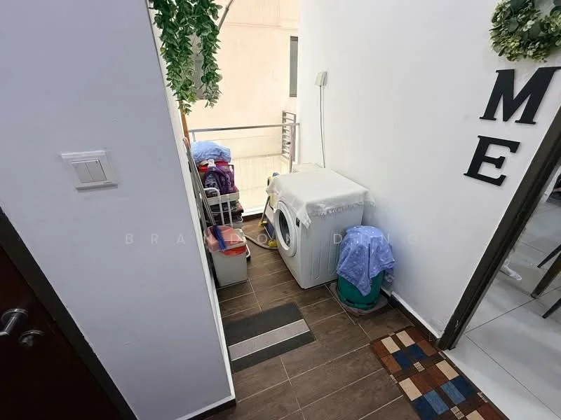 Laundry features: front-load washing machine, tile flooring, white walls, wooden door, decorative wall letters, laundry basket, stacked laundry items, shelf with storage bins; style: modern.