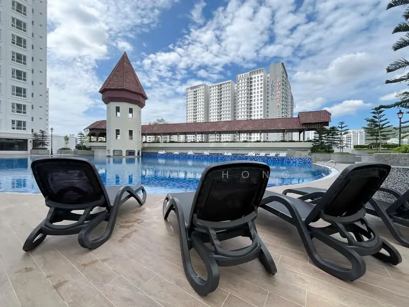 Exterior type: swimming pool deck; features: infinity pool, pool deck with loungers, surrounding landscaping, tropical palm trees, tower feature with pitched roof, residential buildings in background, blue sky with scattered clouds, grey stone-paved walkway; style: modern.