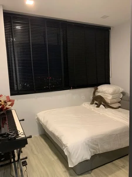 Bedroom features: queen-size bed with white bedding, black horizontal blinds on windows, light wood flooring, grey upholstered headboard, two stacked pillows, piano keyboard, decorative flowers in a vase, city view visible through window; style: modern; view: city.