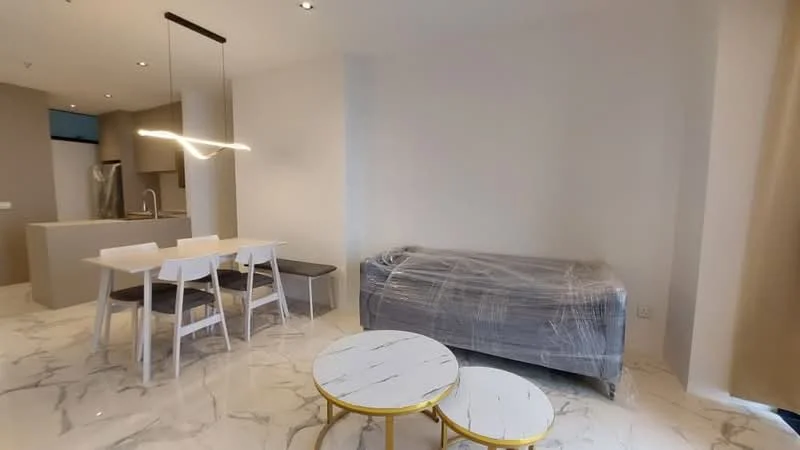 Living features: marble tile flooring, white painted walls, recessed downlights, sofa covered in plastic, 2 round coffee tables with white tops and gold bases, 4-seater dining table with white chairs, dark wood bench, open layout to kitchen, large windows with natural light; style: modern.